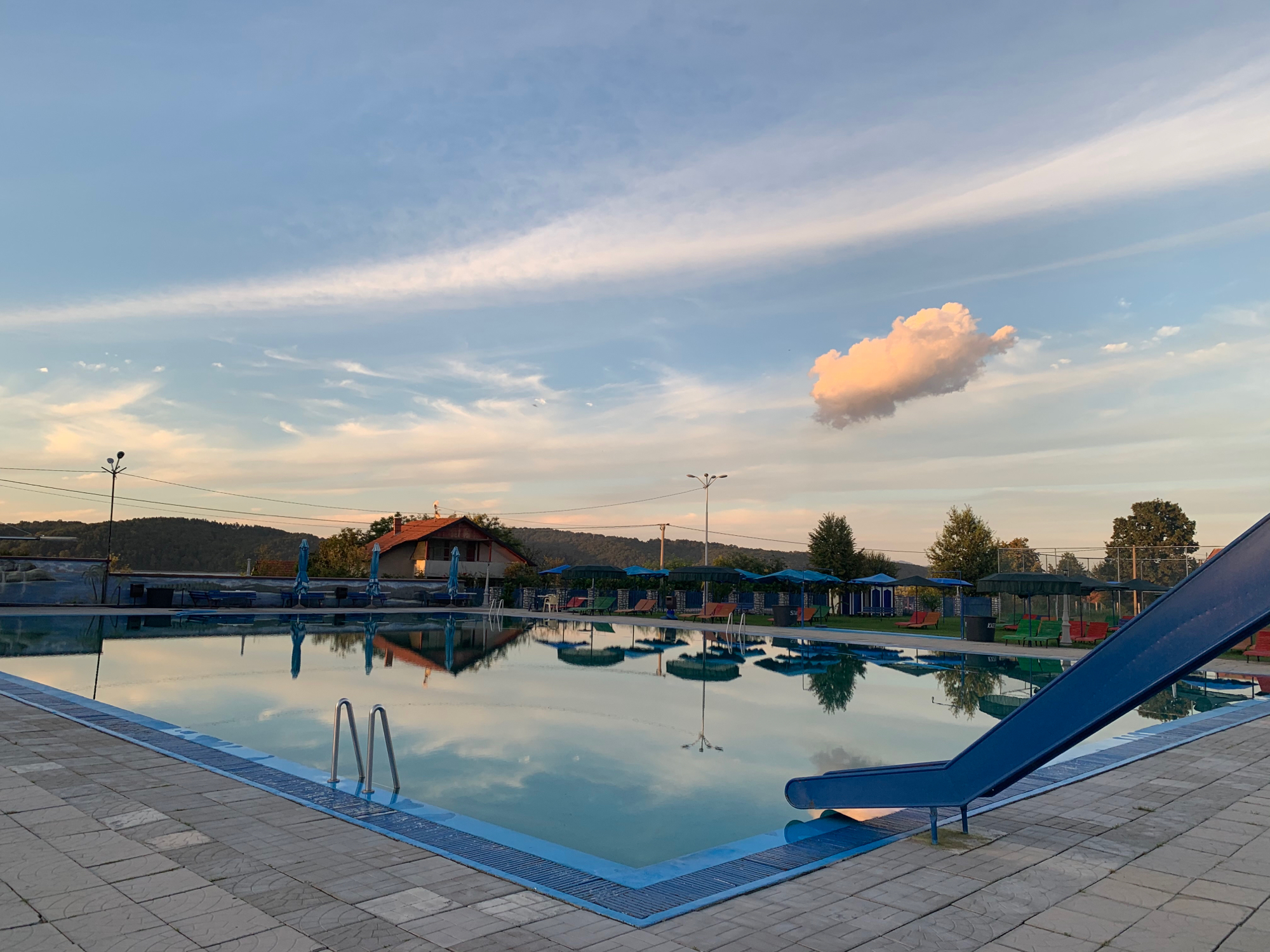 ERNA Resort swimming pool with evening sky reflection