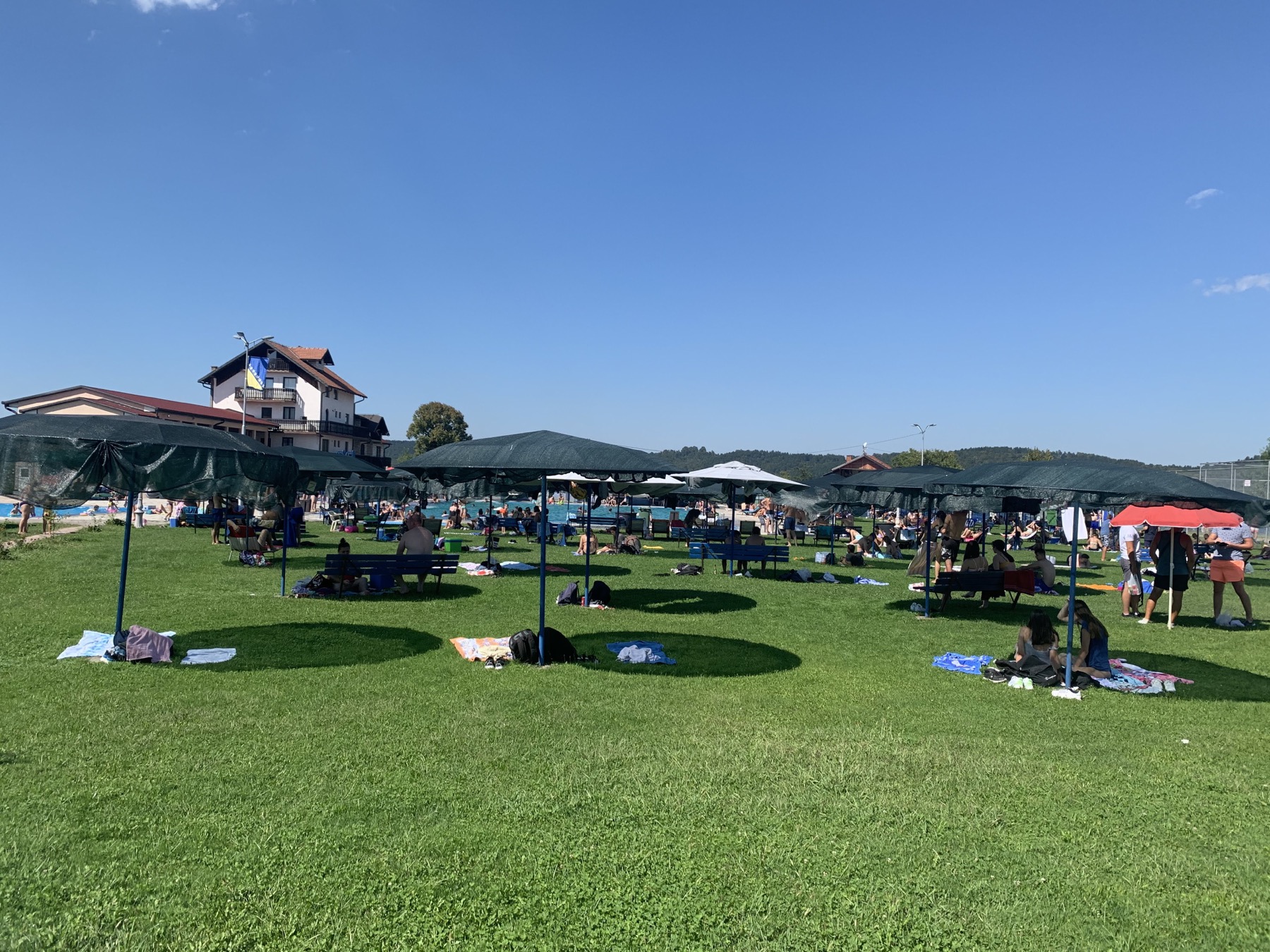 Lawn with loungers and umbrellas at ERNA Resort