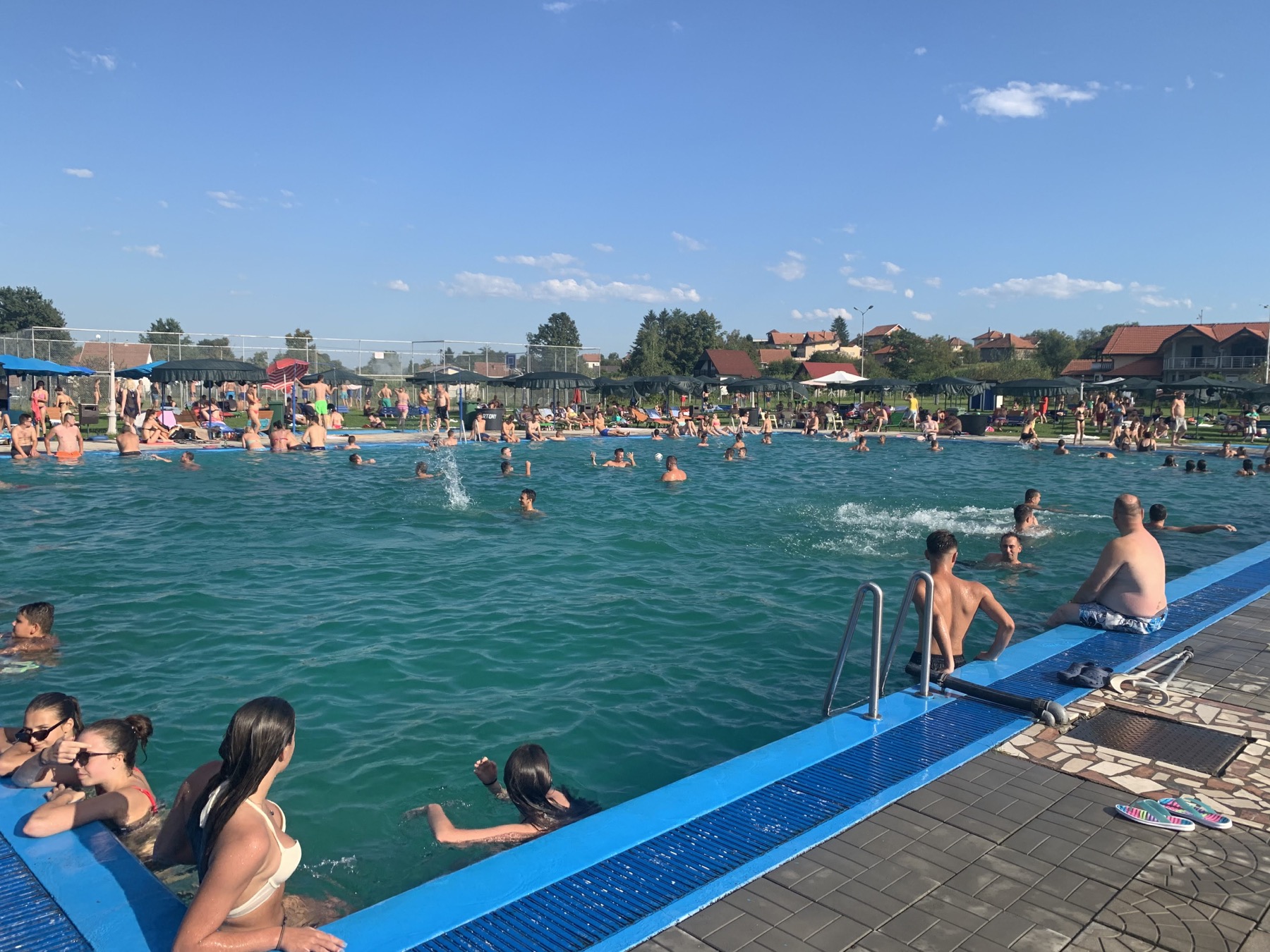 Guests using the main swimming pool at ERNA Resort